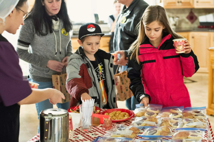 a group of people standing around a table