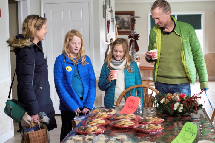 a group of people standing around a table